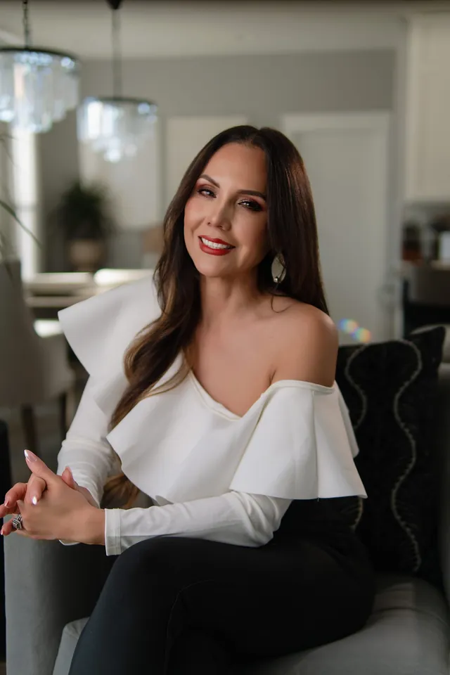 Gissell Rice, founder of Stay Smooth, smiling in a white blouse