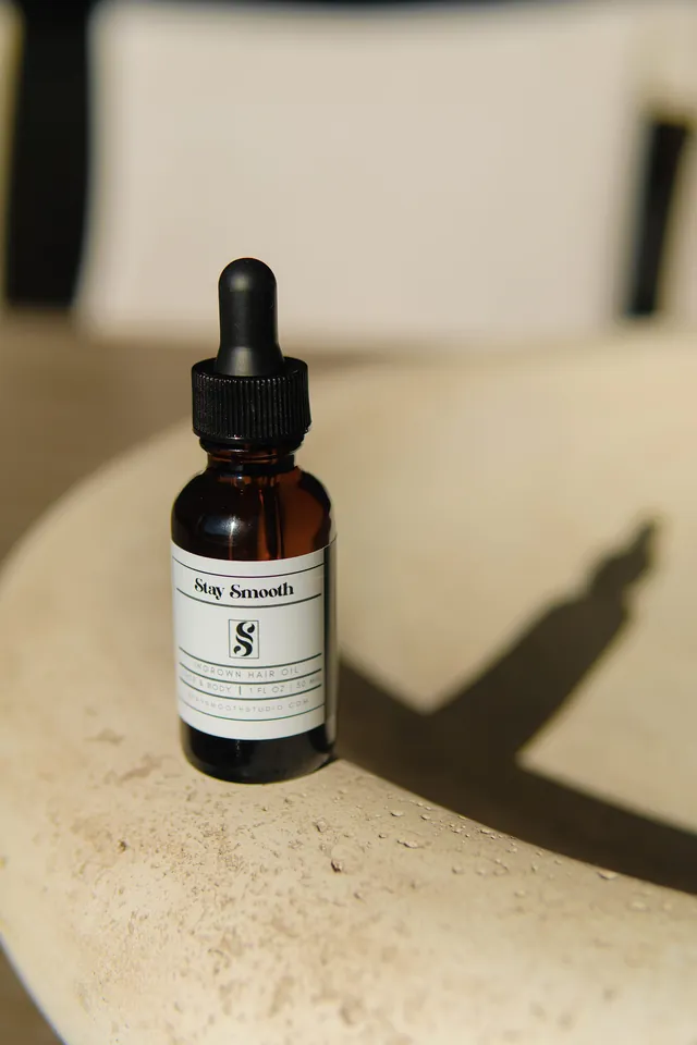 Stay Smooth Ingrown Hair Oil bottle in natural sunlight