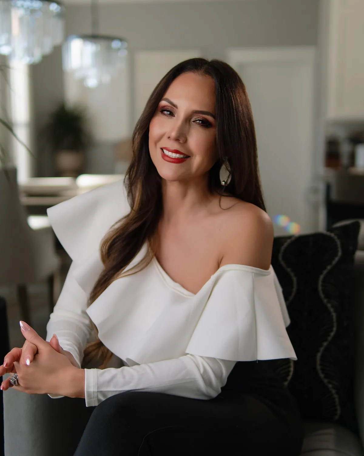 Gissell Rice, Master Esthetician and founder of Stay Smooth Skin Studio, smiling in a white blouse